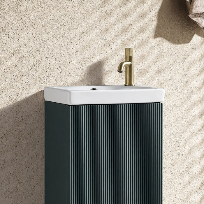 Smoked sage vanity unit with fluted doors and white ceramic basin, brass tap