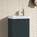 Smoked sage vanity unit with fluted doors and white ceramic basin, brass tap