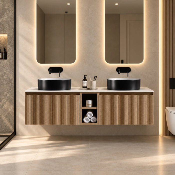 Wall-hung double vanity with fluted oak fronts, two round black sinks and central storage cabinet.