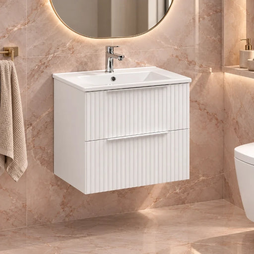 White wall-mounted vanity unit with inset sink and chrome mixer tap in bathroom