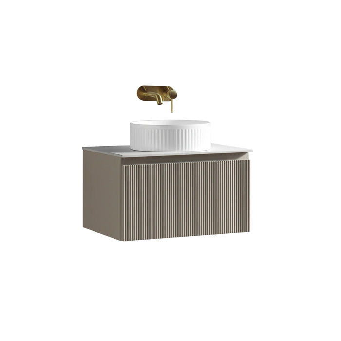 Wall vanity unit with ribbed cabinet, round white sink, and brass faucet