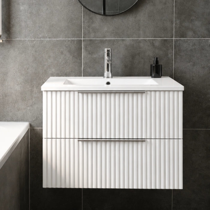 Matt white fluted wall-hung vanity unit with integrated basin and two drawers