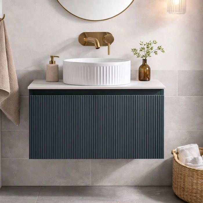 Dark sage wall-hung vanity with ribbed doors, white ridged sink and round mirror above