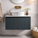 Dark sage wall-hung vanity with ribbed doors, white ridged sink and round mirror above