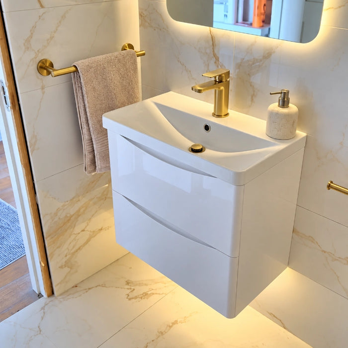 White wall-hung vanity unit with basin and two drawers, gold single-handle taps