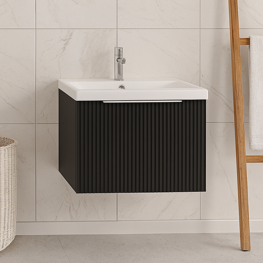 Bathroom vanity with black cabinet and white sink against a tiled wall.