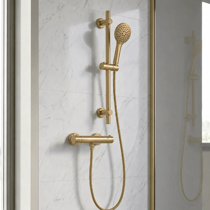 Brushed brass shower system with round handset, T-bar controls, and basin tap