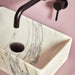 Wall-mounted round basin tap with curved spout, matt black finish