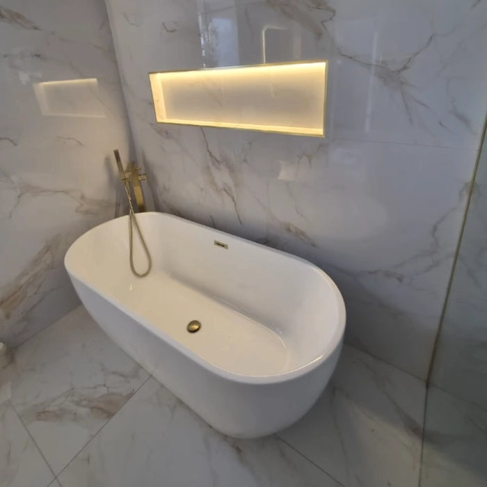 White oval freestanding bathtub with brass deck tap and side overflow outlet, 1650x700mm